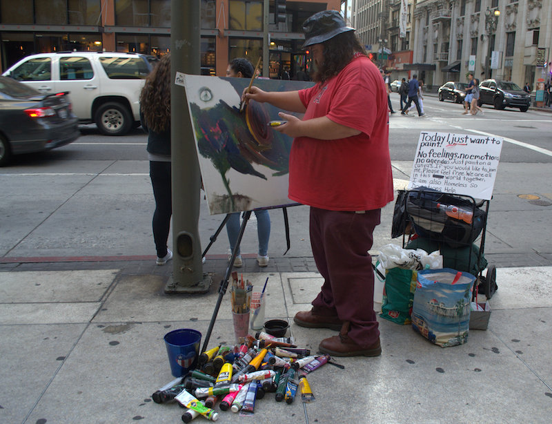 A Homeless Artist Paints Freestyle During The Downtown Art Walk 