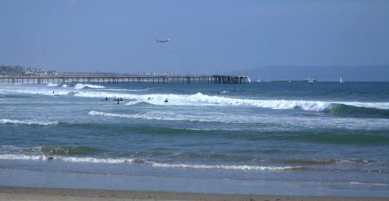 The Venice Beach Boardwalk and a Plane Taking off from LAX