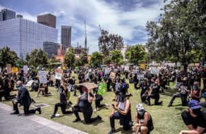 Protesters take a knee in front of City Hall at Grand Park for Black Lives Matter